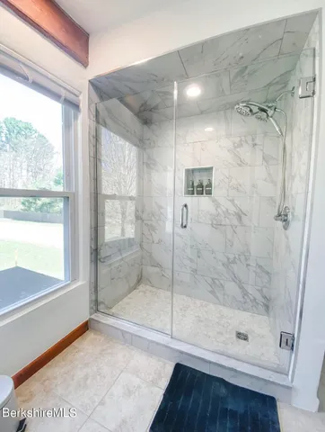 a bathroom with a glass shower door