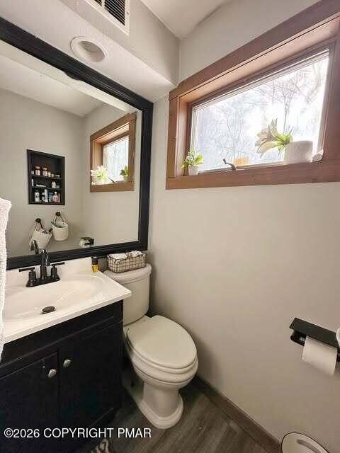 4309 Winchester Way Bushkill, PA 18324 - Photo 24 of 56 a bathroom with a toilet sink vanity and mirror
