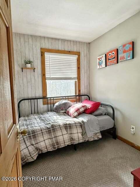 4309 Winchester Way Bushkill, PA 18324 - Photo 25 of 56 a bedroom with a bed and a potted plant on dresser