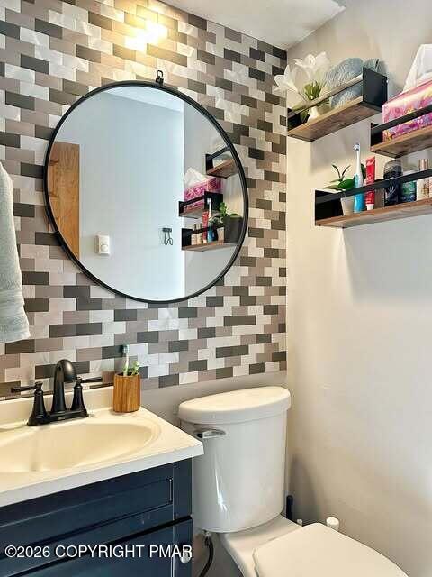 4309 Winchester Way Bushkill, PA 18324 - Photo 30 of 56 a bathroom with a sink a mirror and toilet
