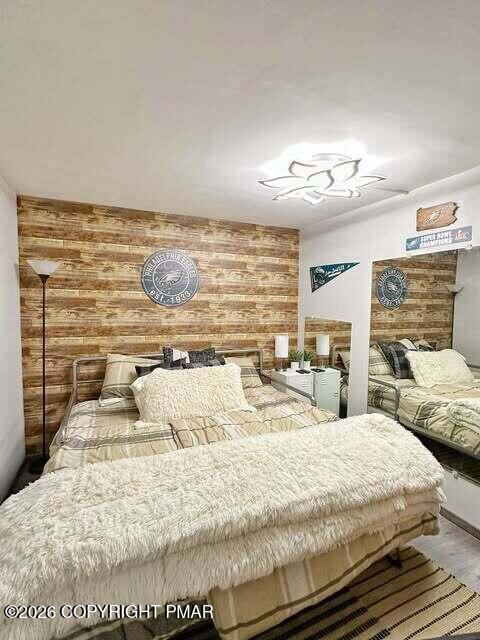 4309 Winchester Way Bushkill, PA 18324 - Photo 42 of 56 a large bedroom with a bed and dresser with wooden floor