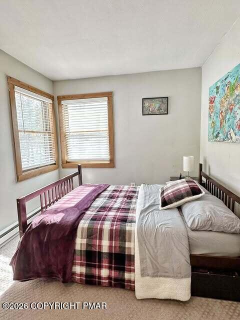 4309 Winchester Way Bushkill, PA 18324 - Photo 7 of 56 a bedroom with a bed lamp and a window