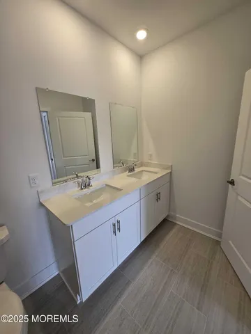 a bathroom with a double vanity sink and a mirror
