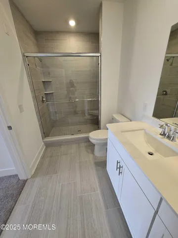 a bathroom with a double vanity sink toilet and shower