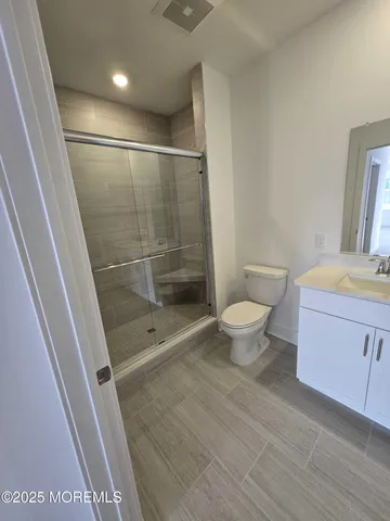 a bathroom with a shower and a toilet