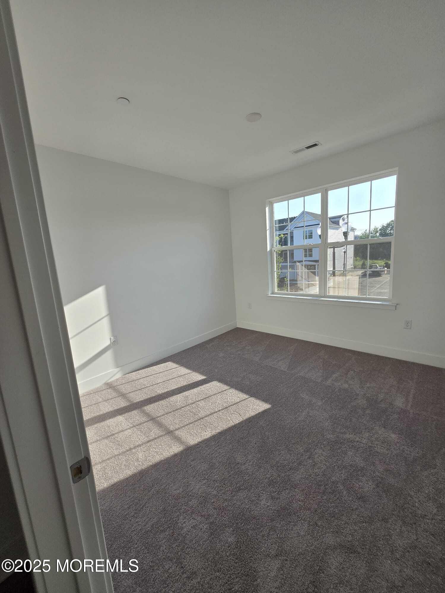 28 Radford Court, Unit 28211 Monroe Township, NJ 08831 - Photo 20 of 33 a view of an empty room with a window