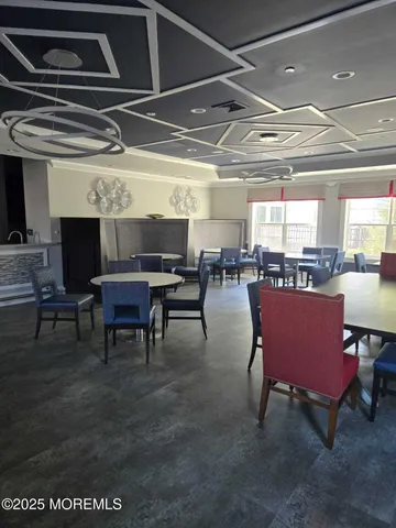 a living room with lots of furniture a rug and a fireplace