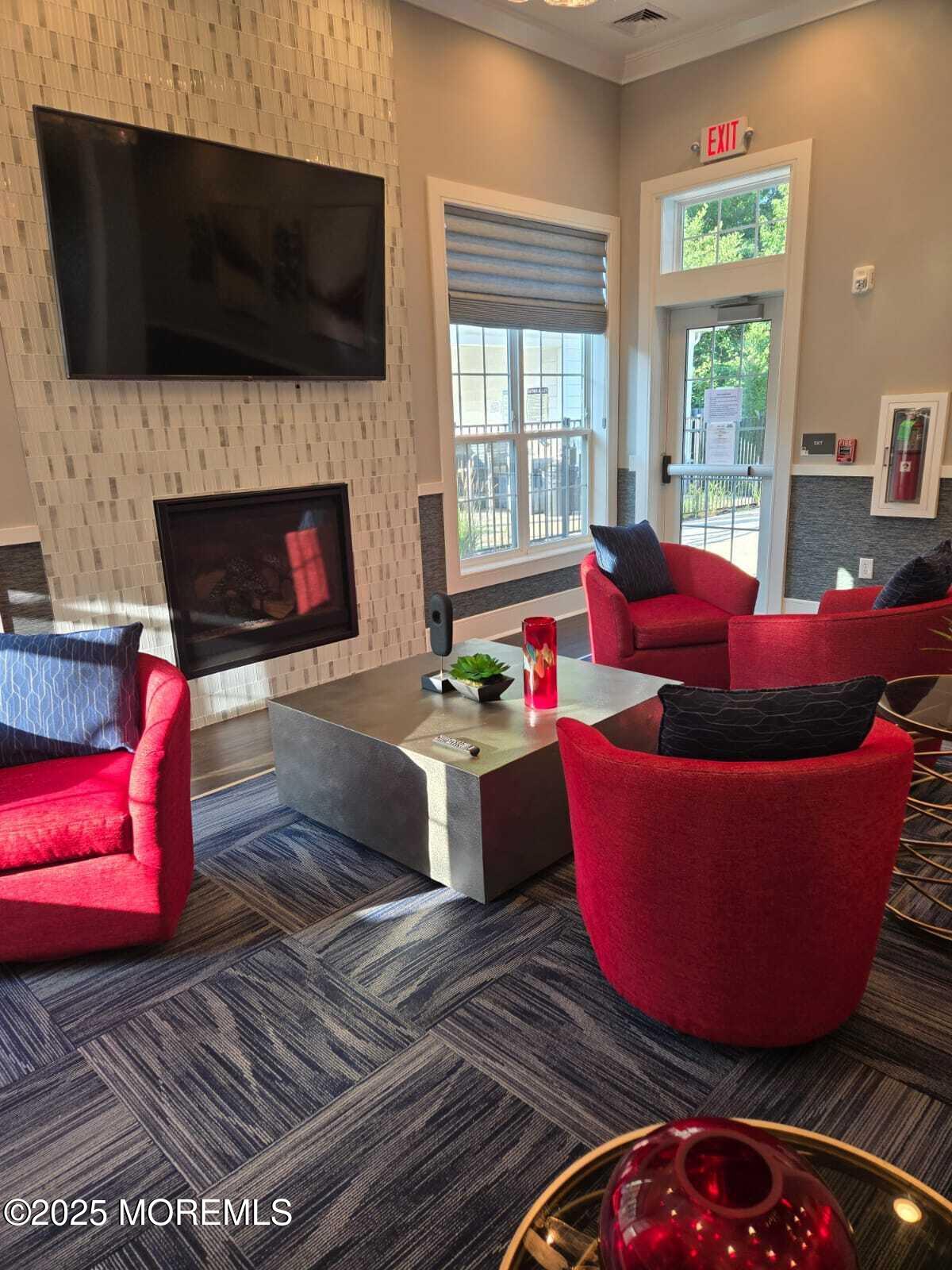 28 Radford Court, Unit 28211 Monroe Township, NJ 08831 - Photo 31 of 33 a living room with furniture a flat screen tv and a fireplace