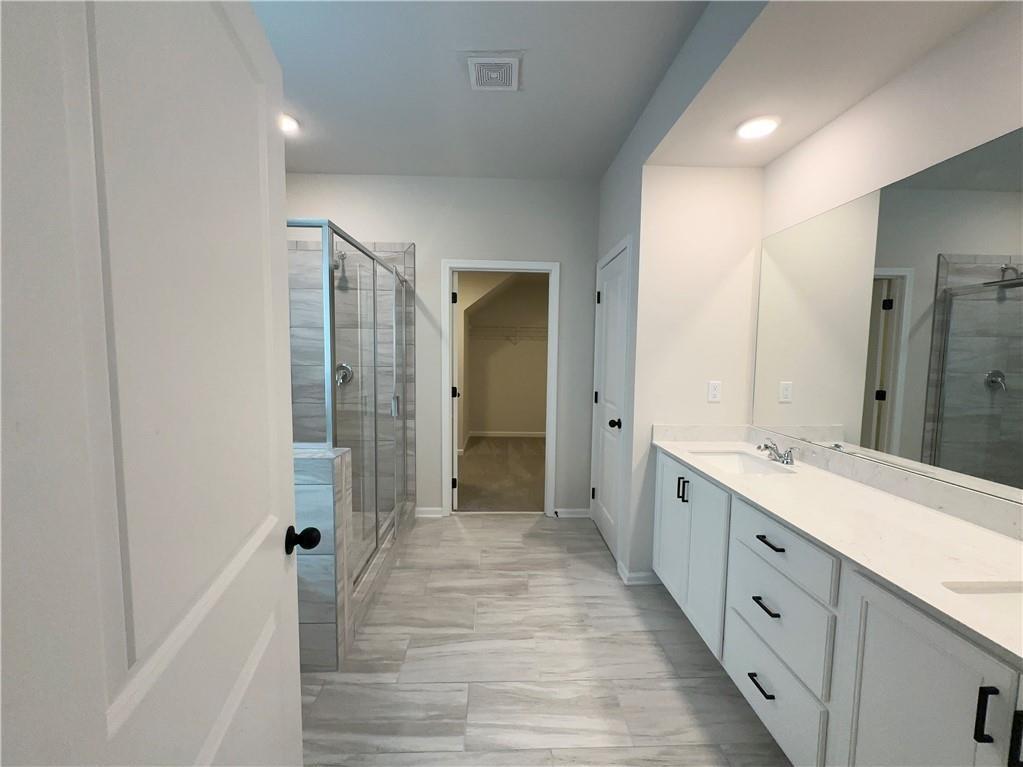 345 Rodeo Drive Auburn, GA 30011 - Photo 16 of 22 a spacious bathroom with a double vanity sink and a mirror