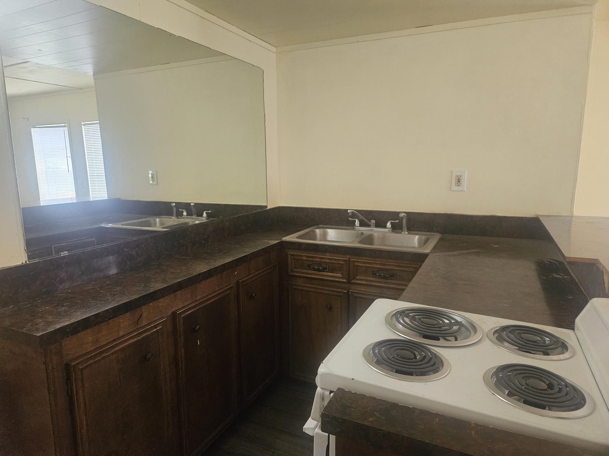 1318-1 Austin Street Rosenberg, TX 77471 - Photo 5 of 5 a kitchen with a sink and stove top oven