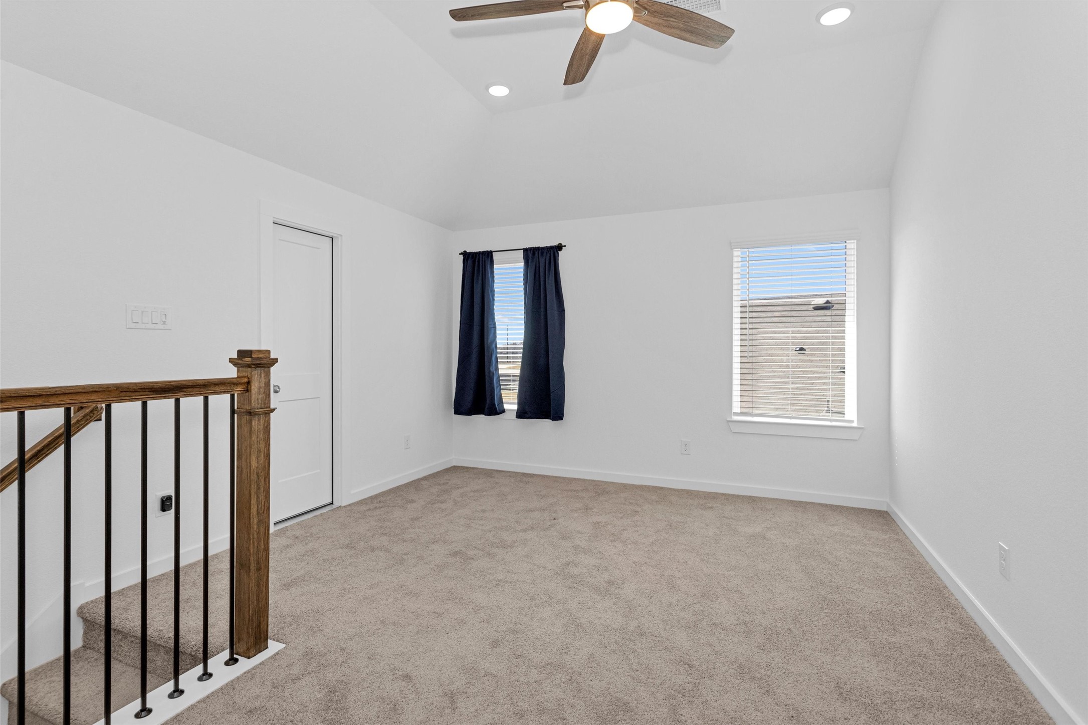 2127 Heather Rdg Way Rosenberg, TX 77471 - Photo 26 of 41 This upstairs game room offers vaulted ceilings, soft carpeting, and plenty of natural light, creating a flexible space for entertainment, a media lounge, or a play area.