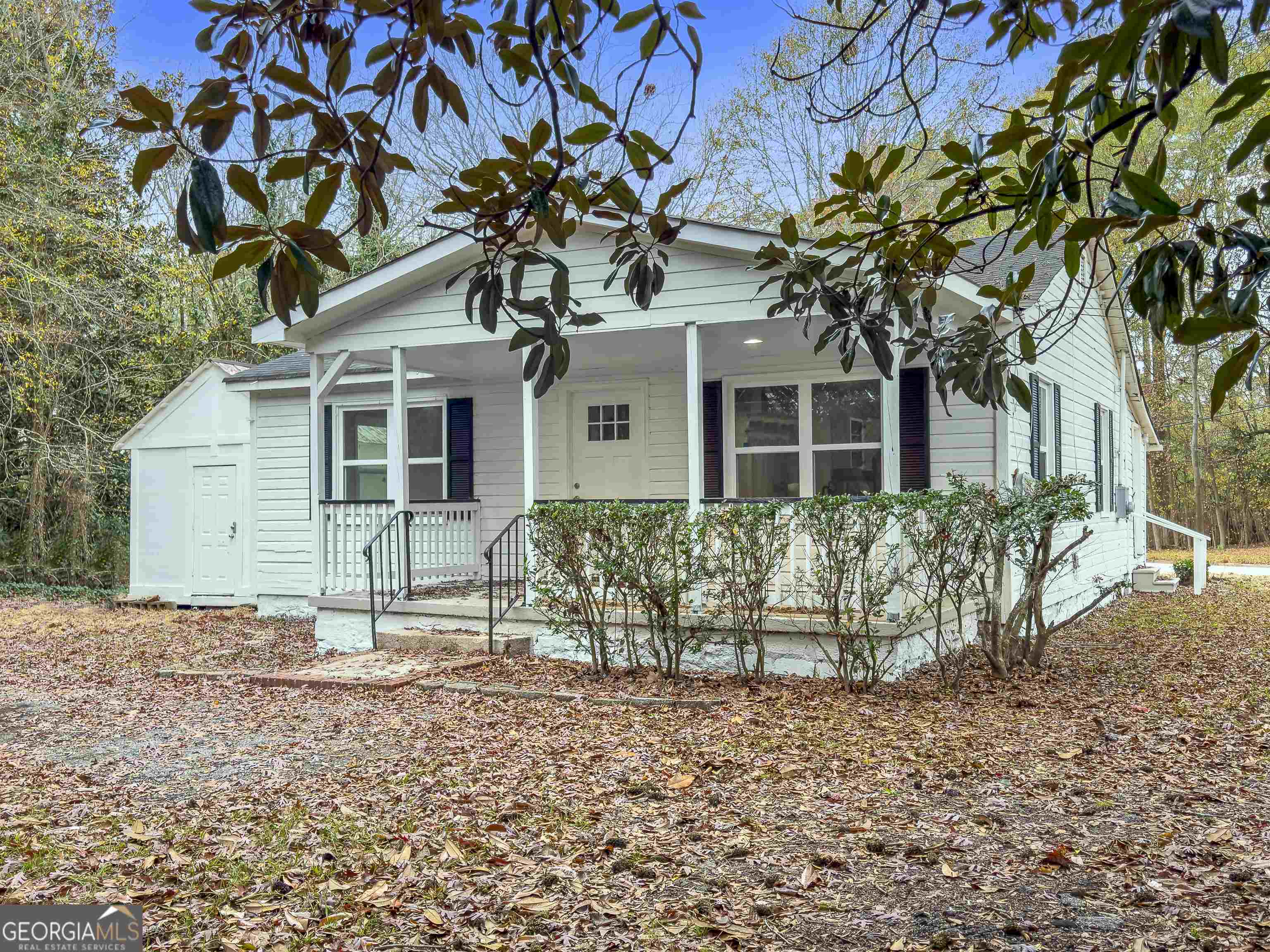 front view of a house with a tree
