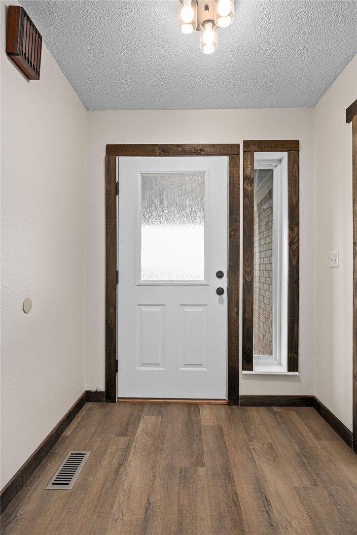 Foyer featuring wood finished floors and a textured ceiling