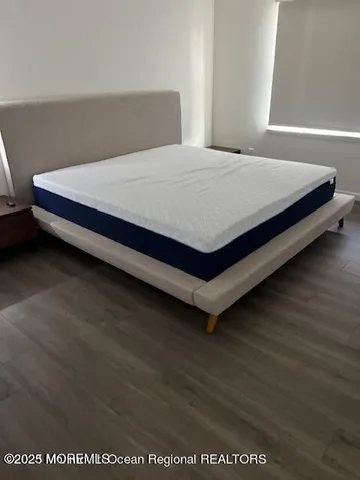 a bed sitting in a bedroom next to a window