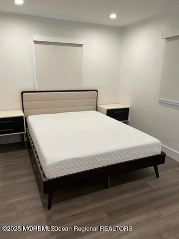 a bed sitting in a bedroom next to a window