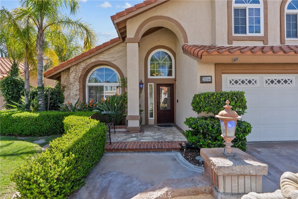 20344 Calhaven Drive Saugus, CA 91390 - Photo 13 of 70 a front view of a house with a yard and potted plants