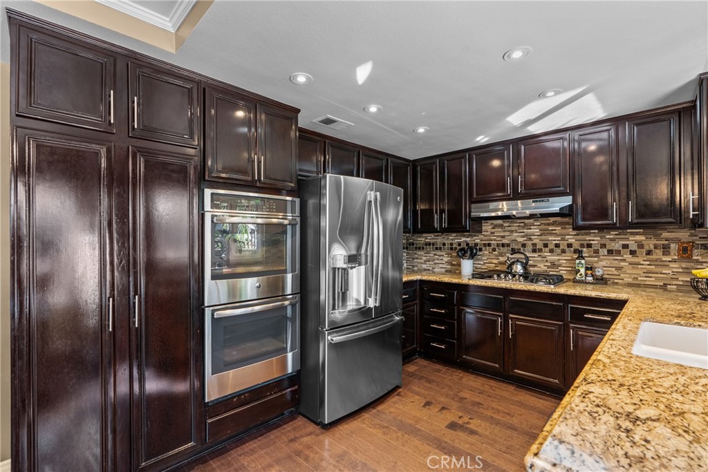 20344 Calhaven Drive Saugus, CA 91390 - Photo 27 of 70 a kitchen with stainless steel appliances granite countertop a refrigerator and a sink