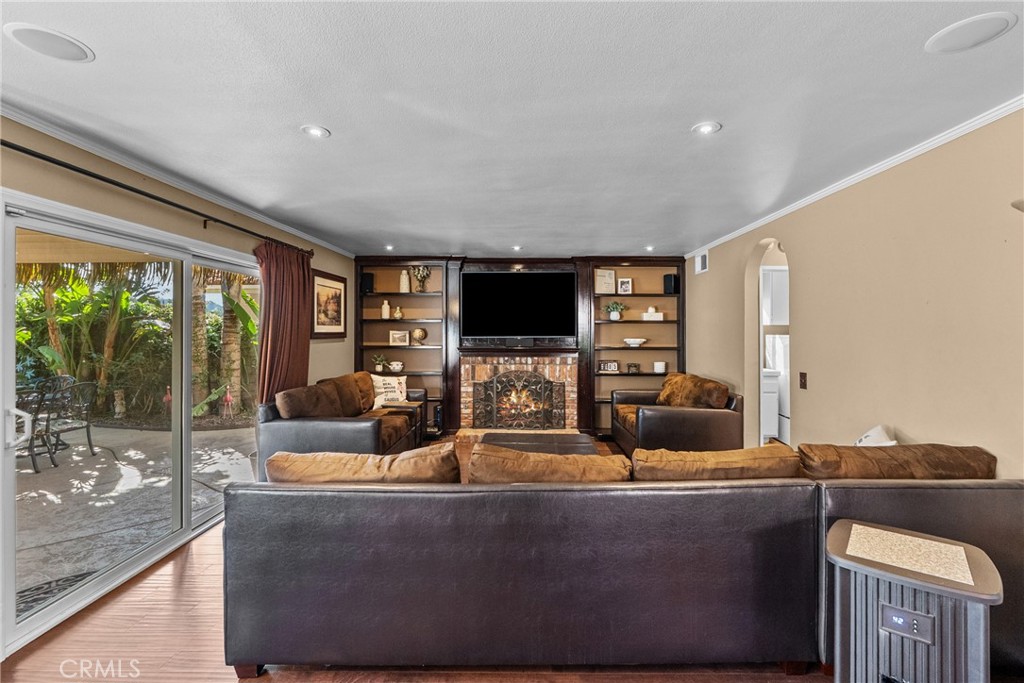 20344 Calhaven Drive Saugus, CA 91390 - Photo 30 of 70 a living room with fireplace furniture and a flat screen tv