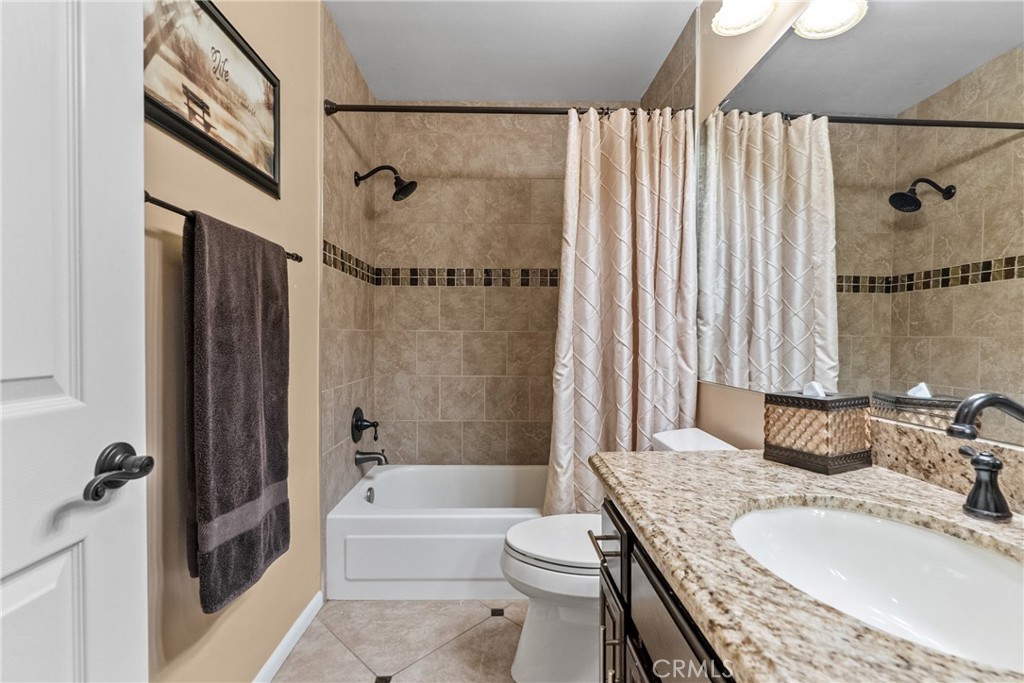 20344 Calhaven Drive Saugus, CA 91390 - Photo 40 of 70 a bathroom with a granite countertop bathtub shower sink vanity and toilet