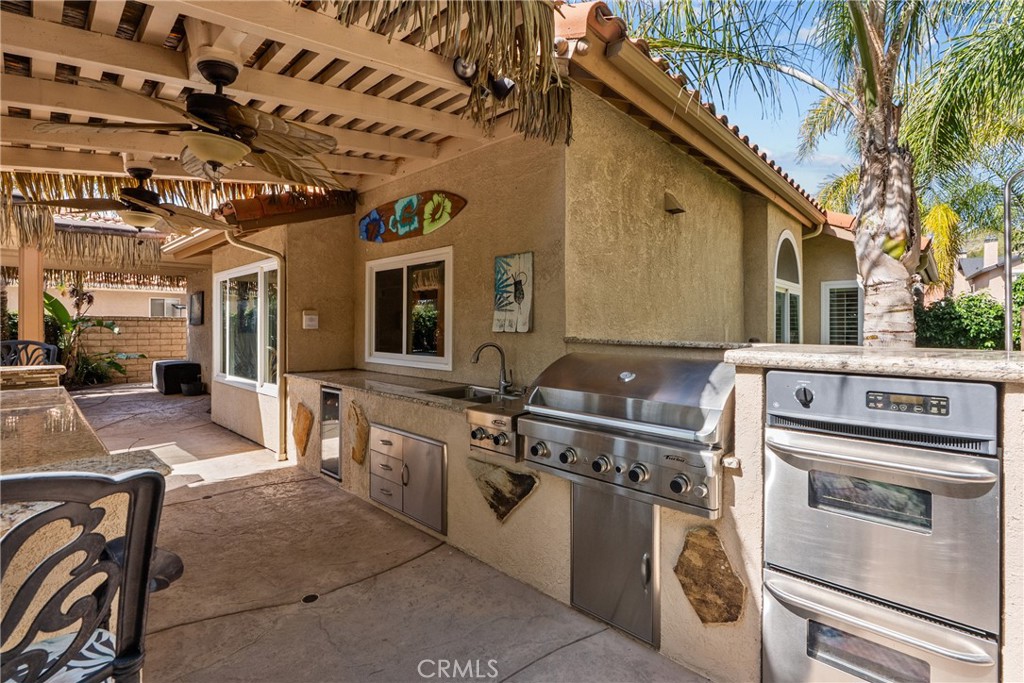 20344 Calhaven Drive Saugus, CA 91390 - Photo 54 of 70 a view of a kitchen with stainless steel appliances granite countertop a stove and a sink