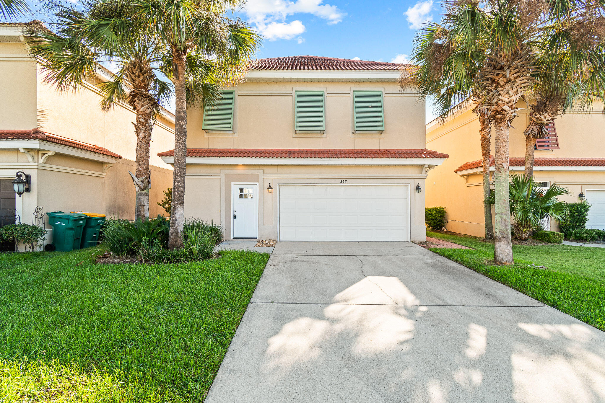 227 Inverrary Drive Destin, FL 32541 - Photo 1 of 50 a view of a white house with a yard and palm trees