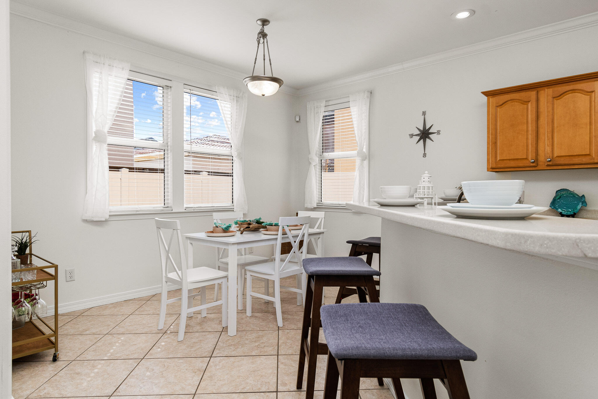 227 Inverrary Drive Destin, FL 32541 - Photo 14 of 50 a kitchen with a dining table chairs and a sink