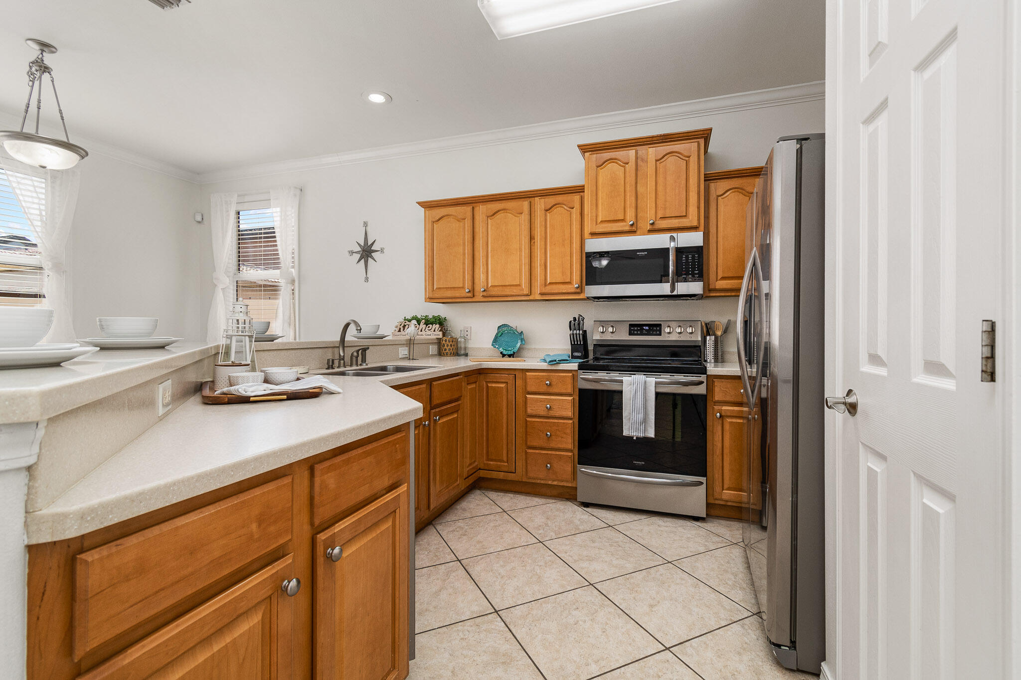 227 Inverrary Drive Destin, FL 32541 - Photo 15 of 50 a kitchen with a sink stove and microwave