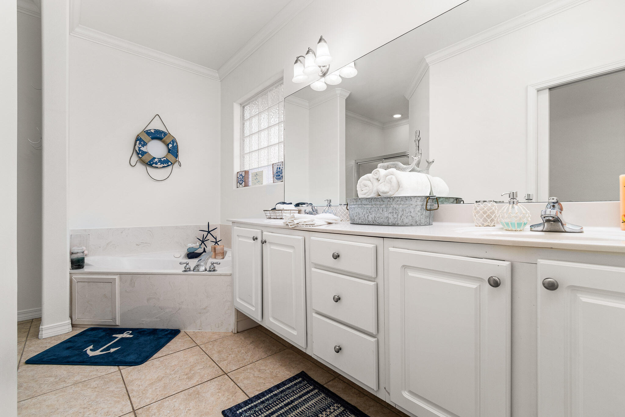 227 Inverrary Drive Destin, FL 32541 - Photo 34 of 50 a bathroom with a sink a mirror and a bathtub
