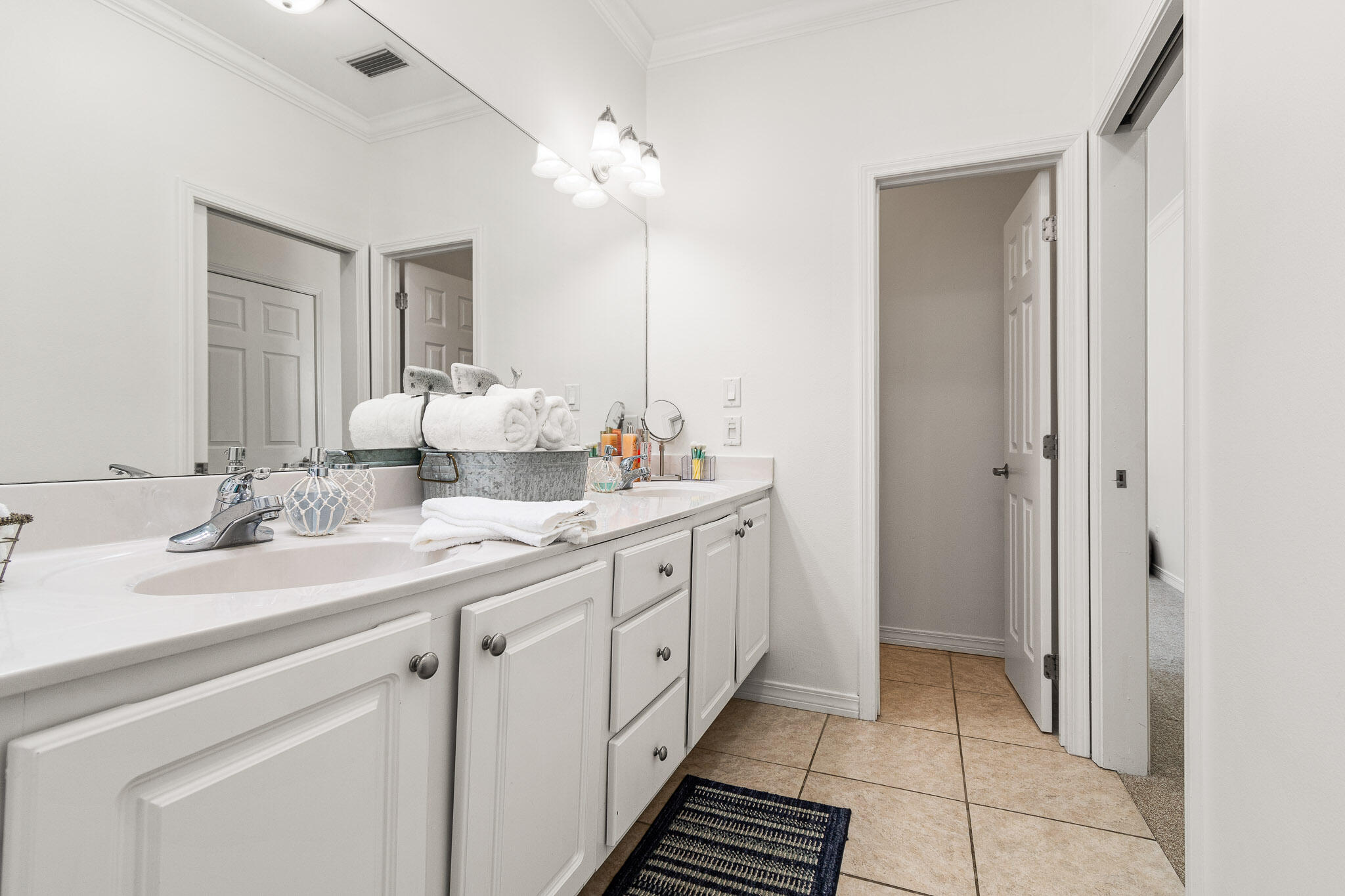 227 Inverrary Drive Destin, FL 32541 - Photo 36 of 50 a bathroom with a double vanity sink and a mirror