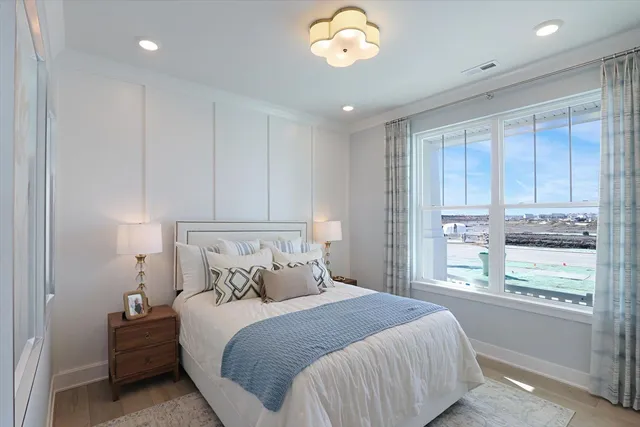 a bedroom with a large bed and a window