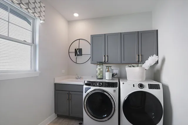 a view of a storage and utility room with washer and dryer