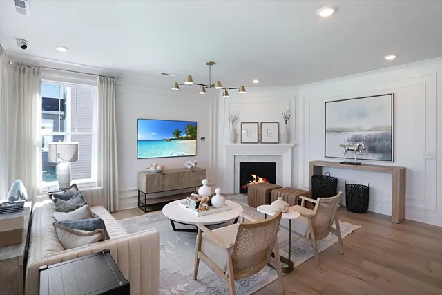 a living room with furniture a fireplace and a table