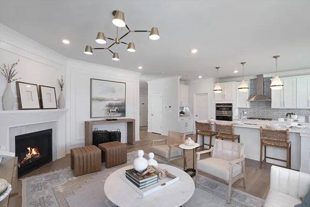 a living room with furniture a fireplace and a table
