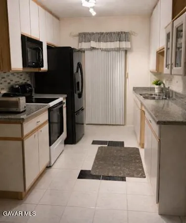 a kitchen with a sink stove and refrigerator