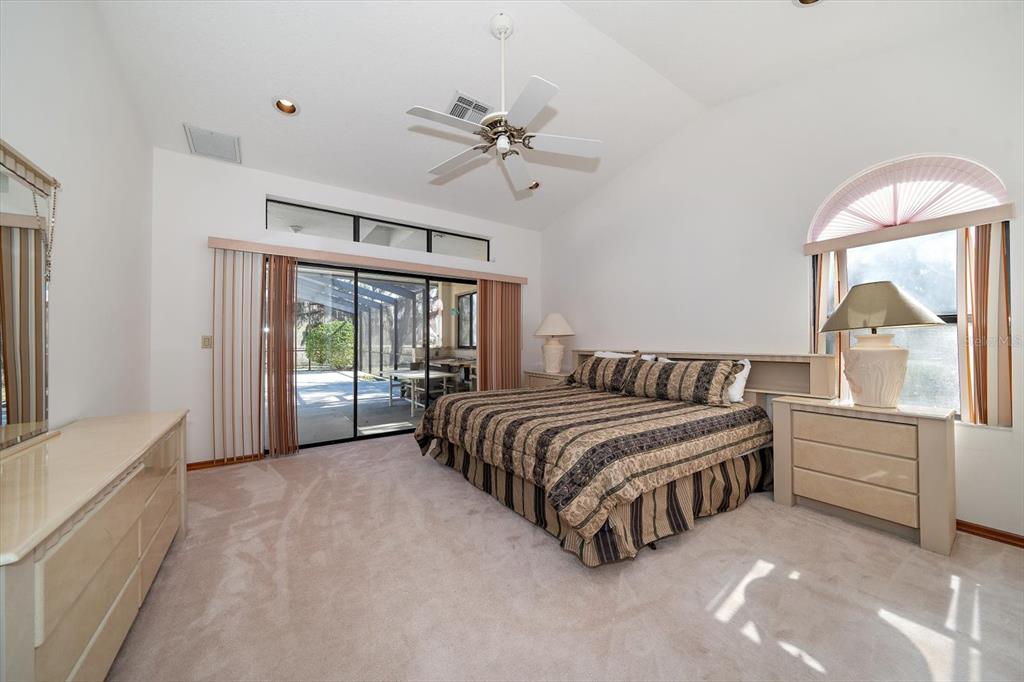 18419 Tyler Road Odessa, FL 33556 - Photo 16 of 38 a spacious bedroom with a bed and a large window