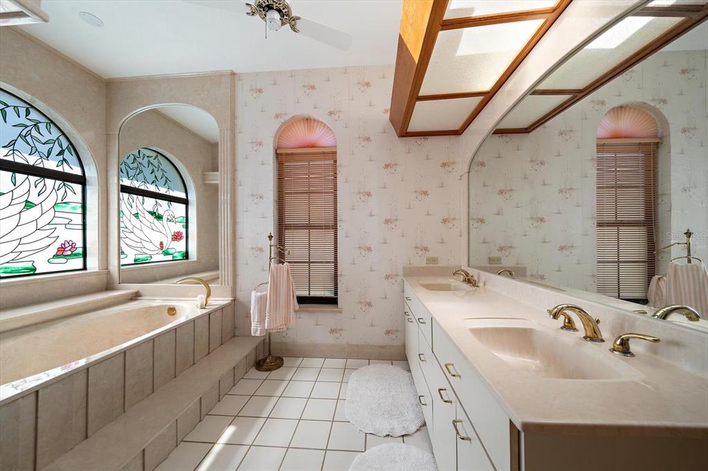 18419 Tyler Road Odessa, FL 33556 - Photo 17 of 38 a bathroom with a tub sink and mirror