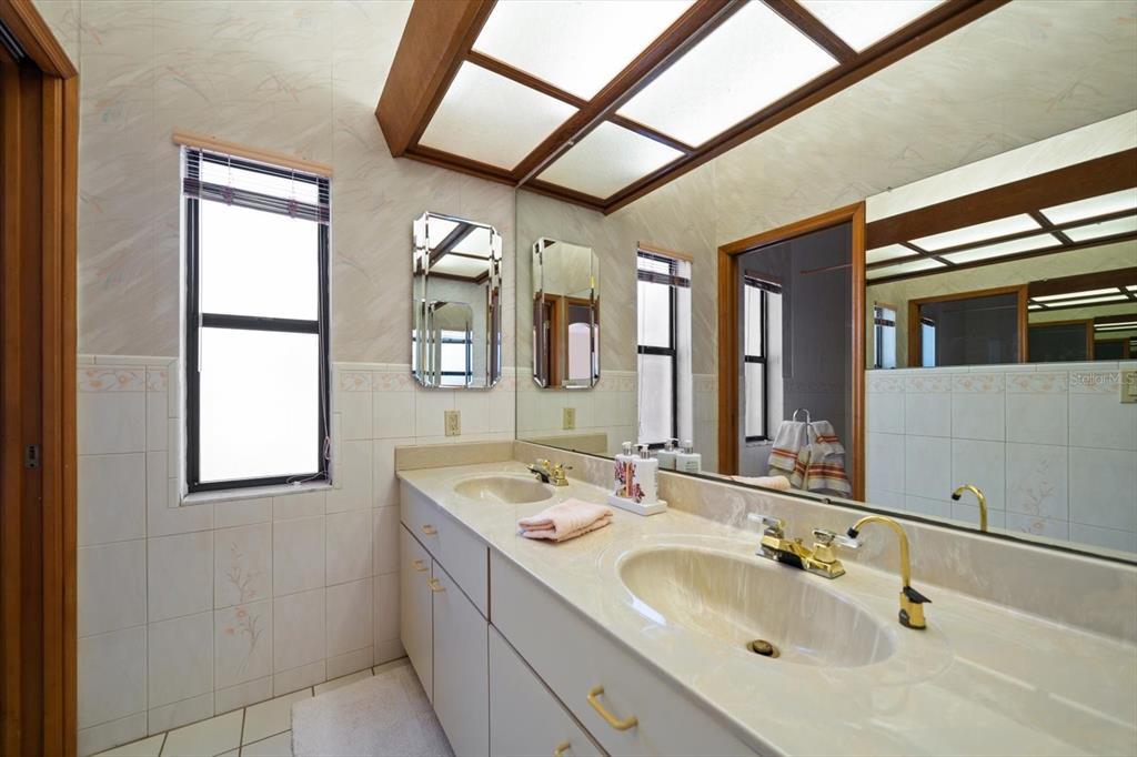 18419 Tyler Road Odessa, FL 33556 - Photo 23 of 38 a bathroom with a double vanity sink and a mirror