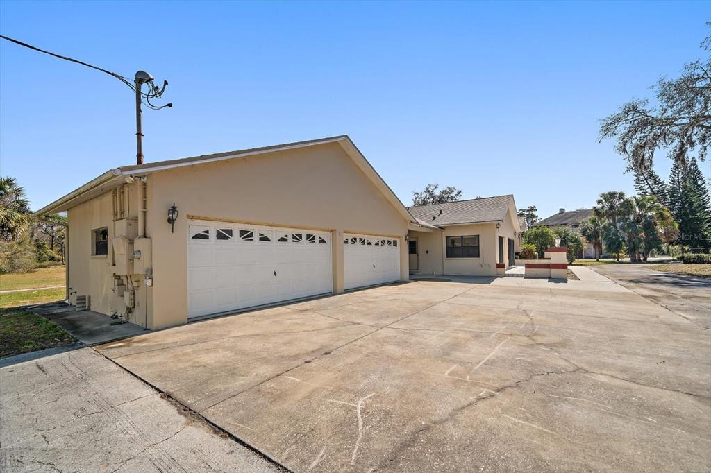 18419 Tyler Road Odessa, FL 33556 - Photo 27 of 38 a front view of a house with a yard and garage