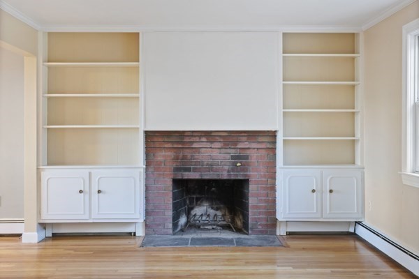 88 Wright Road Concord, MA 01742 - Photo 20 of 42 a living room with a fireplace and a wooden floor