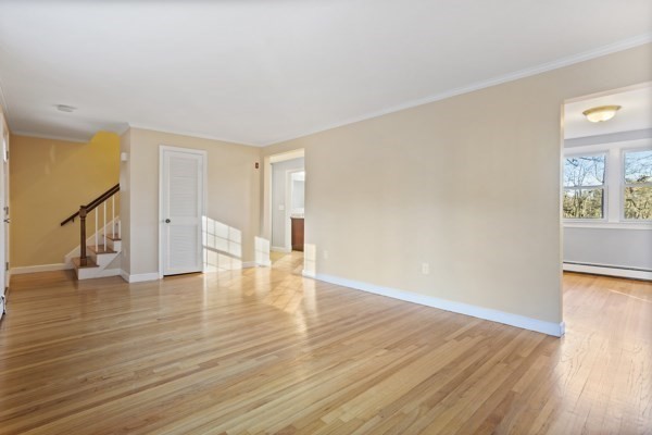 88 Wright Road Concord, MA 01742 - Photo 22 of 42 a view of an empty room with wooden floor and a window