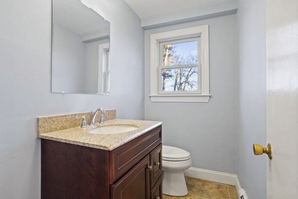88 Wright Road Concord, MA 01742 - Photo 5 of 42 a bathroom with a toilet sink vanity and mirror