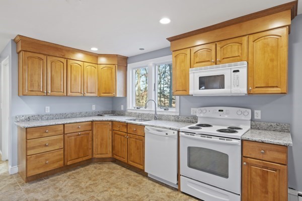 88 Wright Road Concord, MA 01742 - Photo 6 of 42 a kitchen with granite countertop cabinets stainless steel appliances a sink and a window