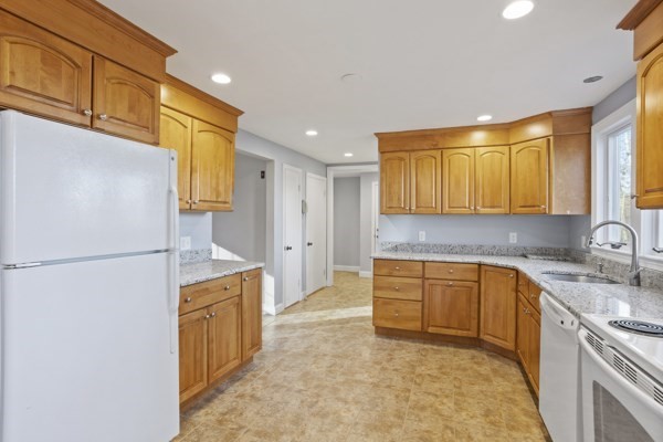 88 Wright Road Concord, MA 01742 - Photo 8 of 42 a kitchen with a sink a refrigerator and cabinets