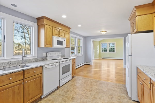 88 Wright Road Concord, MA 01742 - Photo 9 of 42 a kitchen with stainless steel appliances granite countertop a stove a sink and a refrigerator