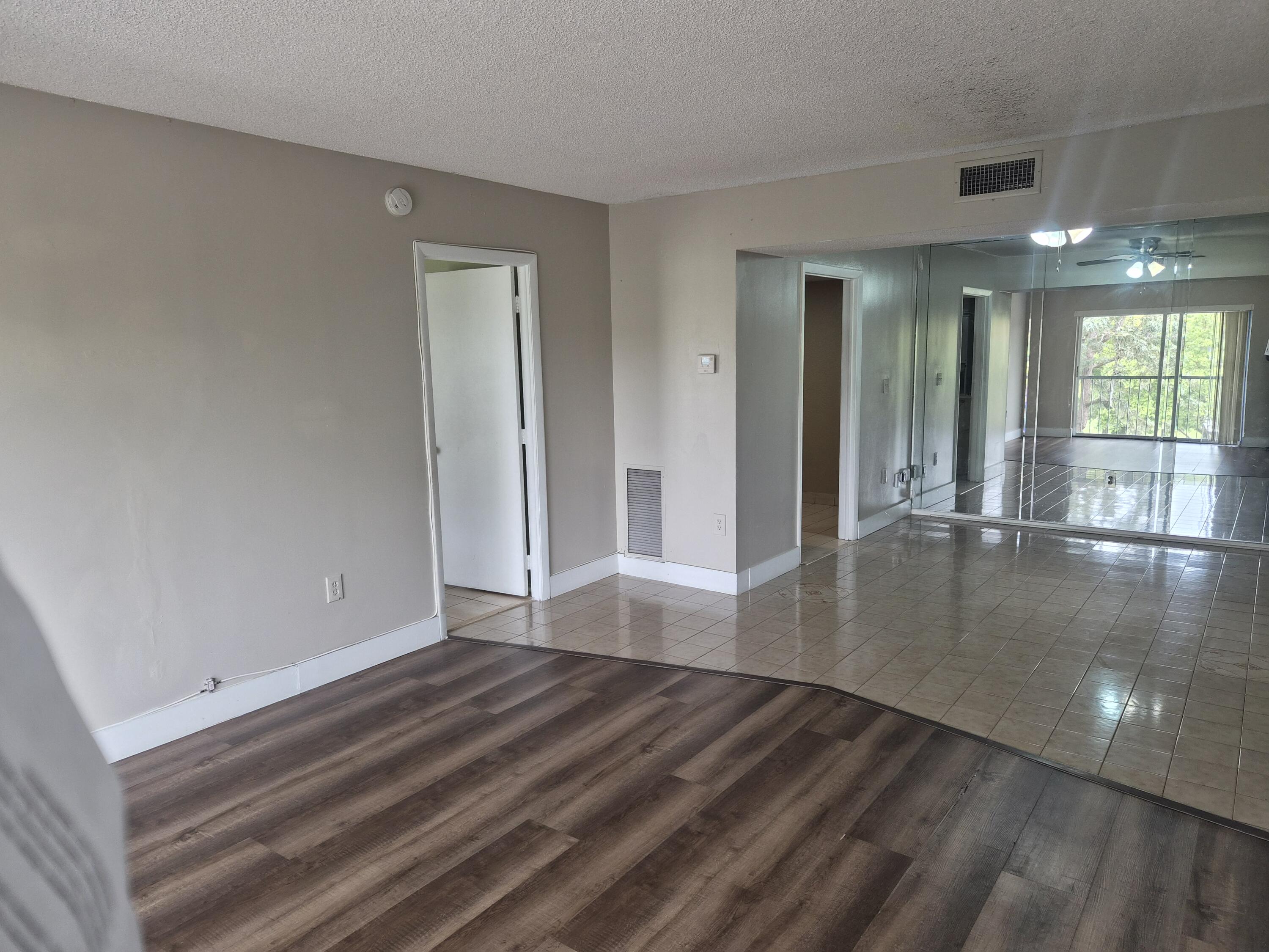 4166 Inverrary Drive, Unit 403 Lauderhill, FL 33319 - Photo 13 of 32 a view of empty room with wooden floor