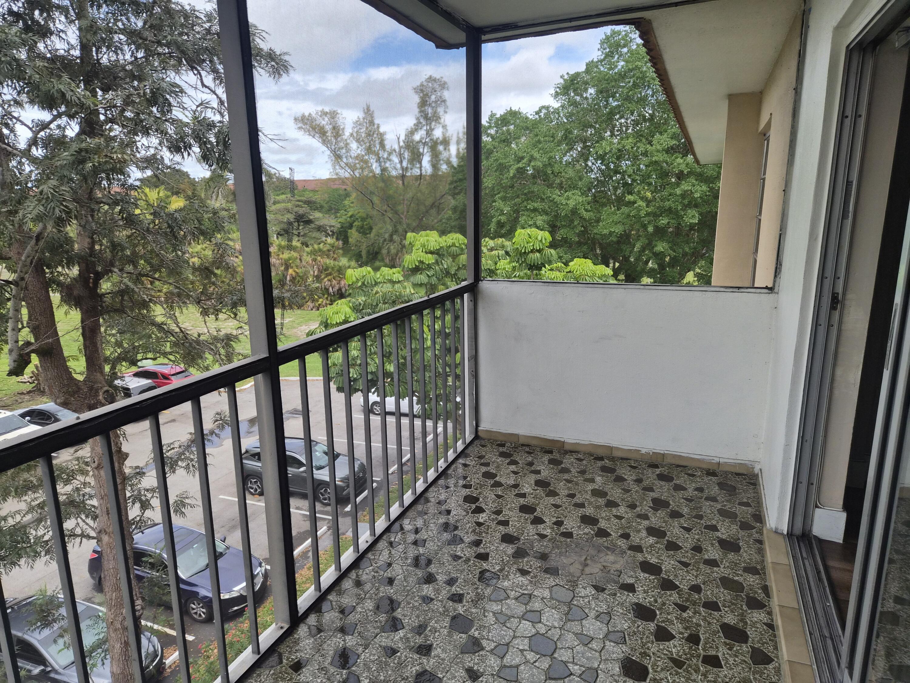 4166 Inverrary Drive, Unit 403 Lauderhill, FL 33319 - Photo 15 of 32 a view of a balcony with wooden floor