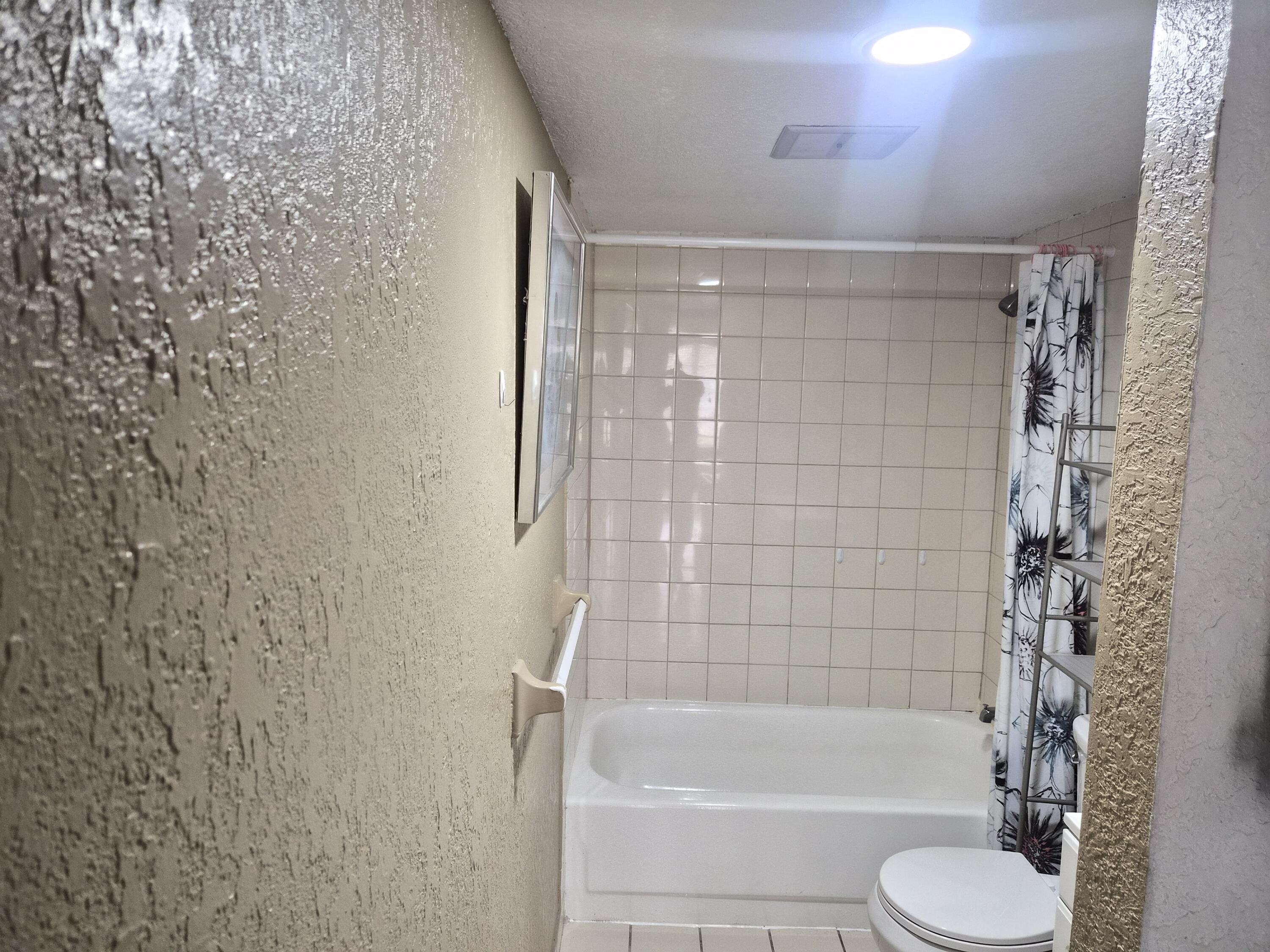 4166 Inverrary Drive, Unit 403 Lauderhill, FL 33319 - Photo 20 of 32 a bathroom with a shower and a toilet
