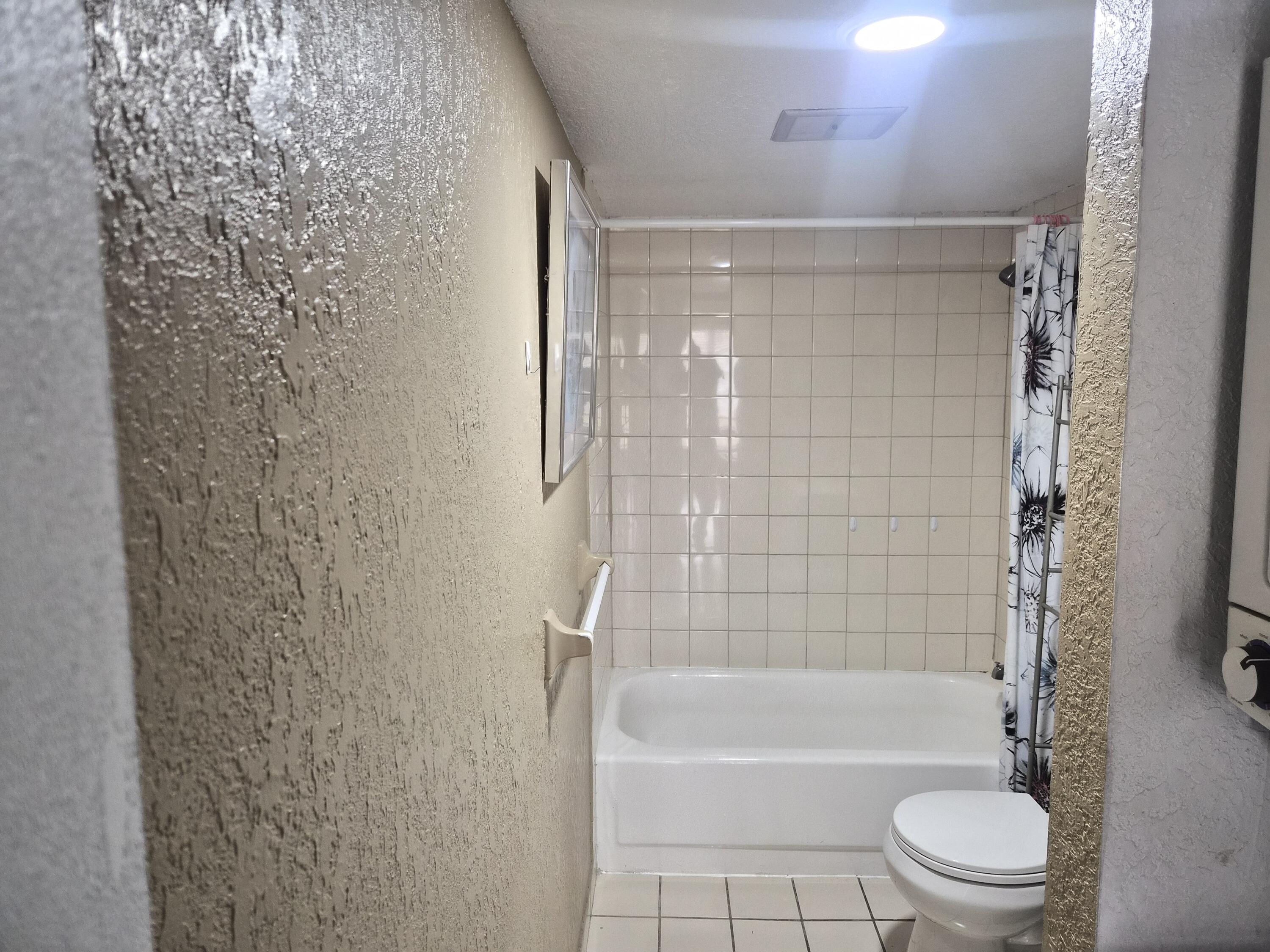 4166 Inverrary Drive, Unit 403 Lauderhill, FL 33319 - Photo 22 of 32 a bathroom with a shower and a toilet