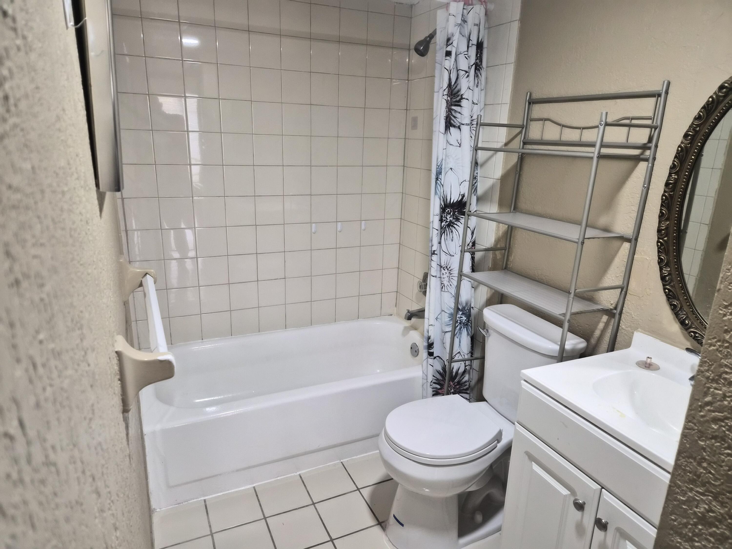 4166 Inverrary Drive, Unit 403 Lauderhill, FL 33319 - Photo 23 of 32 a bathroom with a toilet and a bathtub