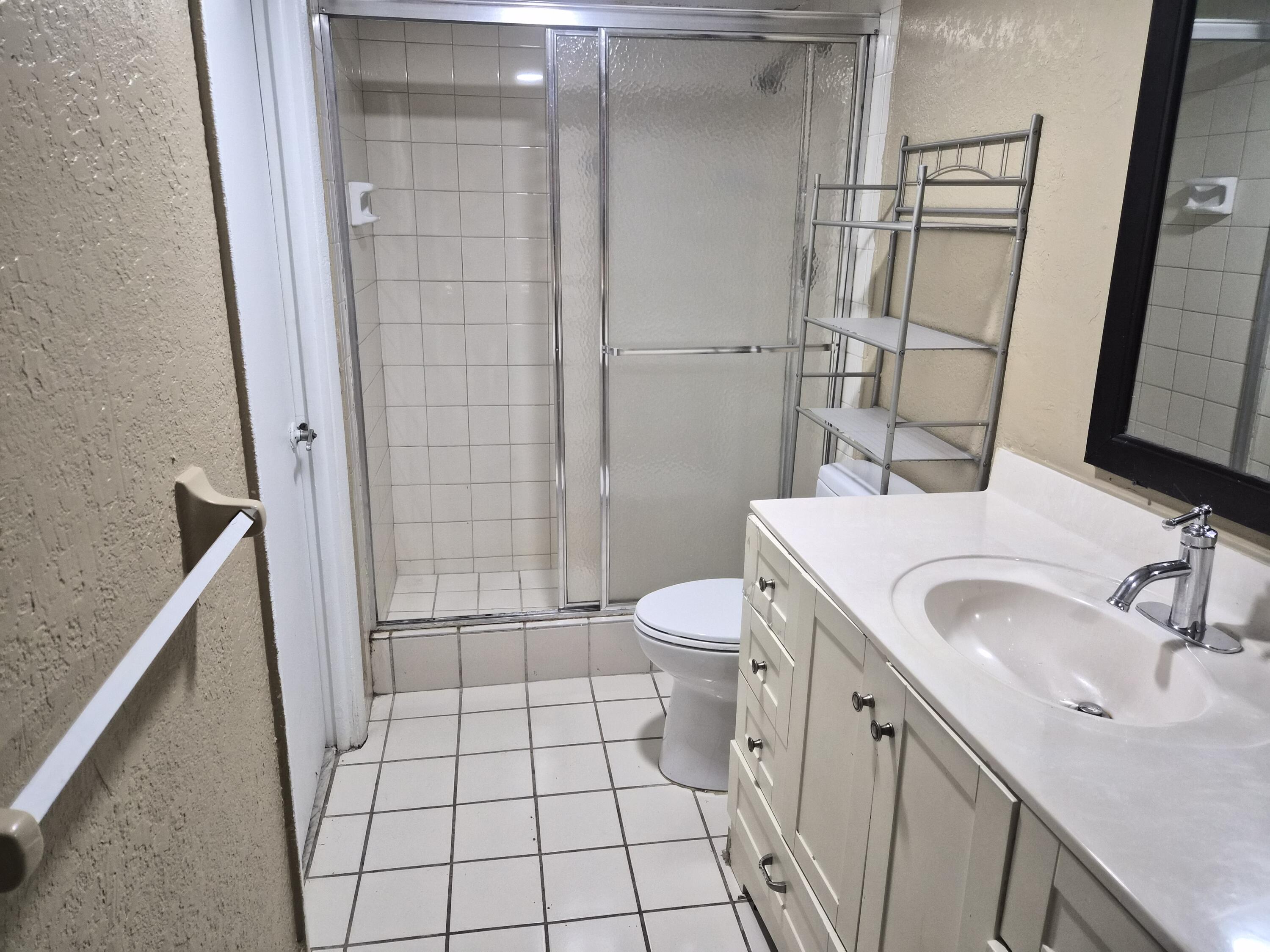 4166 Inverrary Drive, Unit 403 Lauderhill, FL 33319 - Photo 28 of 32 a bathroom with a sink a toilet and shower